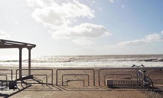 Bike fence on beach during daytime photo