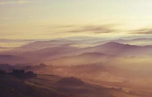 Silhouetted mountain during golden sunset photo