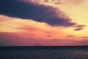 Body of water under cloudy sky during sunset photo