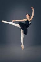 Portrait of the ballerina in ballet pose photo