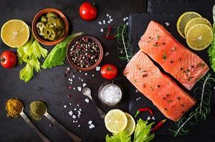 Raw salmon fillet and ingredients for cooking photo