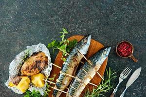 Grilled mackerel fish with baked potatoes photo