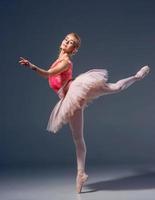 Portrait of the ballerina in ballet pose photo