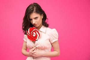 Young woman holding lollipop