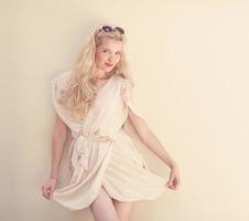 Summer portrait of young beautiful blond woman in white dress photo