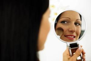 Woman Using a Make-up Brush photo