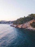 Blue ocean near a cliff photo