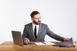 Businessman works at desk on white background photo