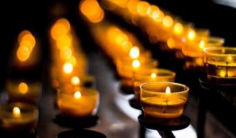 Rows of illuminated candles photo