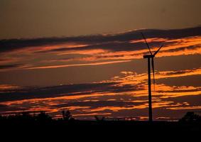 Dark clouds form during orange sunset photo