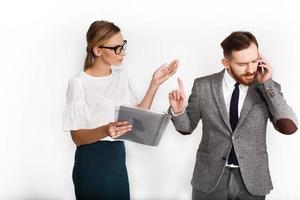 Man talks on the phone while woman tries to explain something photo