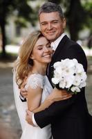 Bride and groom embrace in the sunshine photo