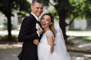 Bride and groom embrace in the sunshine photo