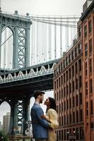 Attractive couple embraces in city street photo