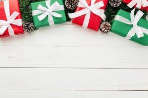 Flat lay of Christmas presents on white wooden background photo