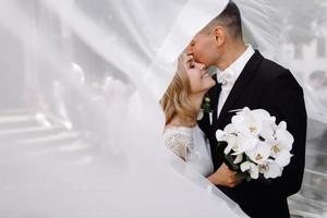 Bride and groom embrace in the sunshine photo