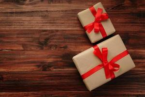 Top view of Christmas gifts on wooden surface photo