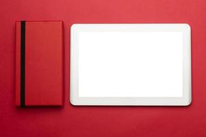 Tablet mockup with red phone cover on red background photo