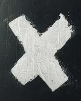 White painted x on black wall photo