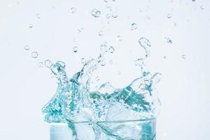 Water splash in a glass on white background photo