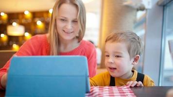 Mother and her son with touchpad video
