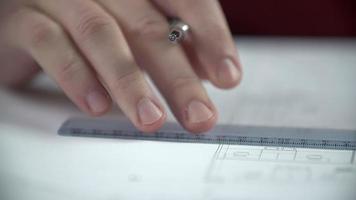 Hands draw lines with biro using the ruler video