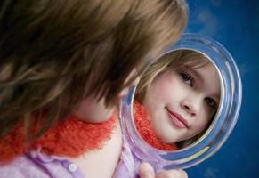 Little Girl Looking a Mirror photo