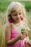 girl holding bunch of flowers photo