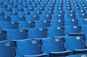Empty plastic seats in a stadium photo