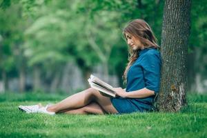 Girl reading a book in park photo