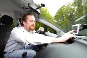 Driver using  GPS navigation a way photo