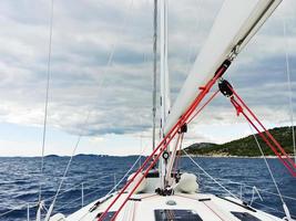voyage on yacht in Adriatic sea over rainy clouds photo