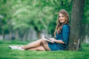 Girl reading a book in park photo