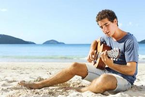 guitar player on the beach photo