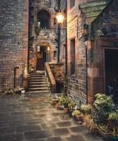 Illuminated lamp post above stone pathway in Dean Village, Scotland photo