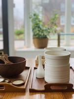 White ceramic bowls on a wooden tray photo