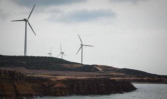 Wind turbines near sea photo