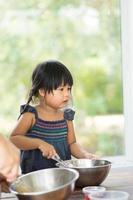 Asian girl cooking in the kitchen photo