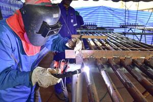 Person welding a pipe photo