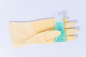 Sanitary glove and alcohol gel on white background photo