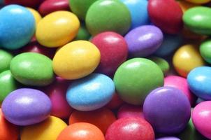 Macro detail of pile of colored smarties photo