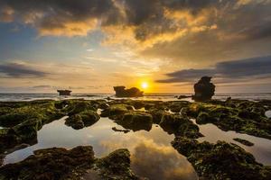Beautiful Sunset with green mossy rock