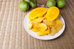 Delicious Yellow Manggo Fruit sliced on white plate photo