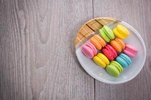 Sweet colorful macaroons on a wood background photo