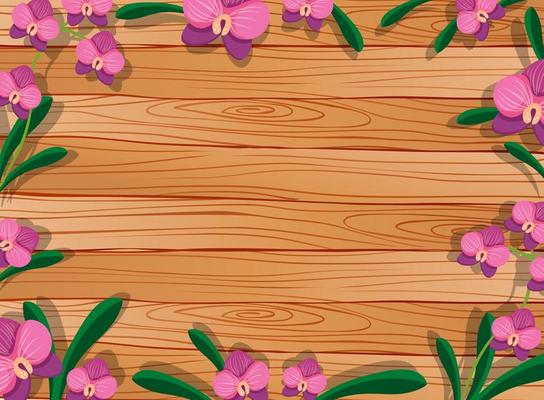 Blank wooden table with leaves and pink orchids