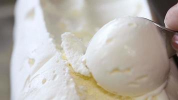 scooping vanilla ice cream ball