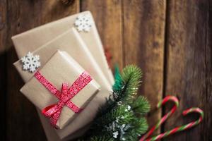 Christmas presents on a wooden background with candy photo