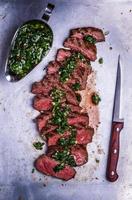 Sliced beef barbecue steak with chimichurri sauce