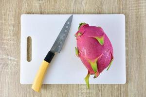 A dragon fruit on a cutting board photo