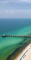 Wood dock on green sea photo